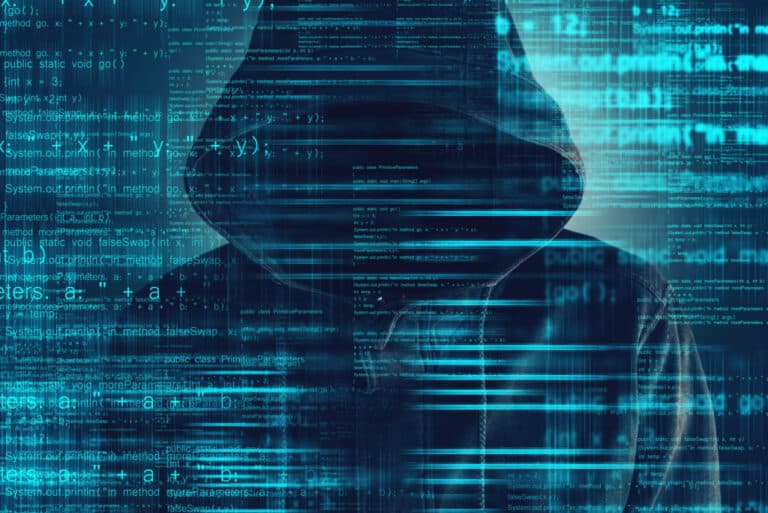 a hooded man in front of a digital background