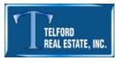 a blue sign that says telford real estate, inc