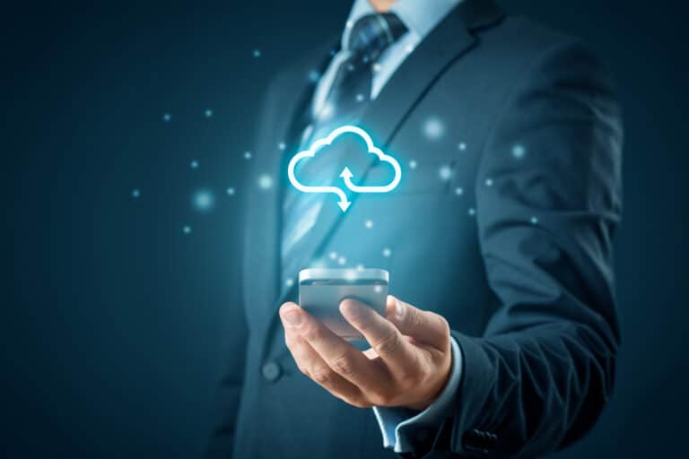 a man in a suit holding a cell phone with a cloud above it