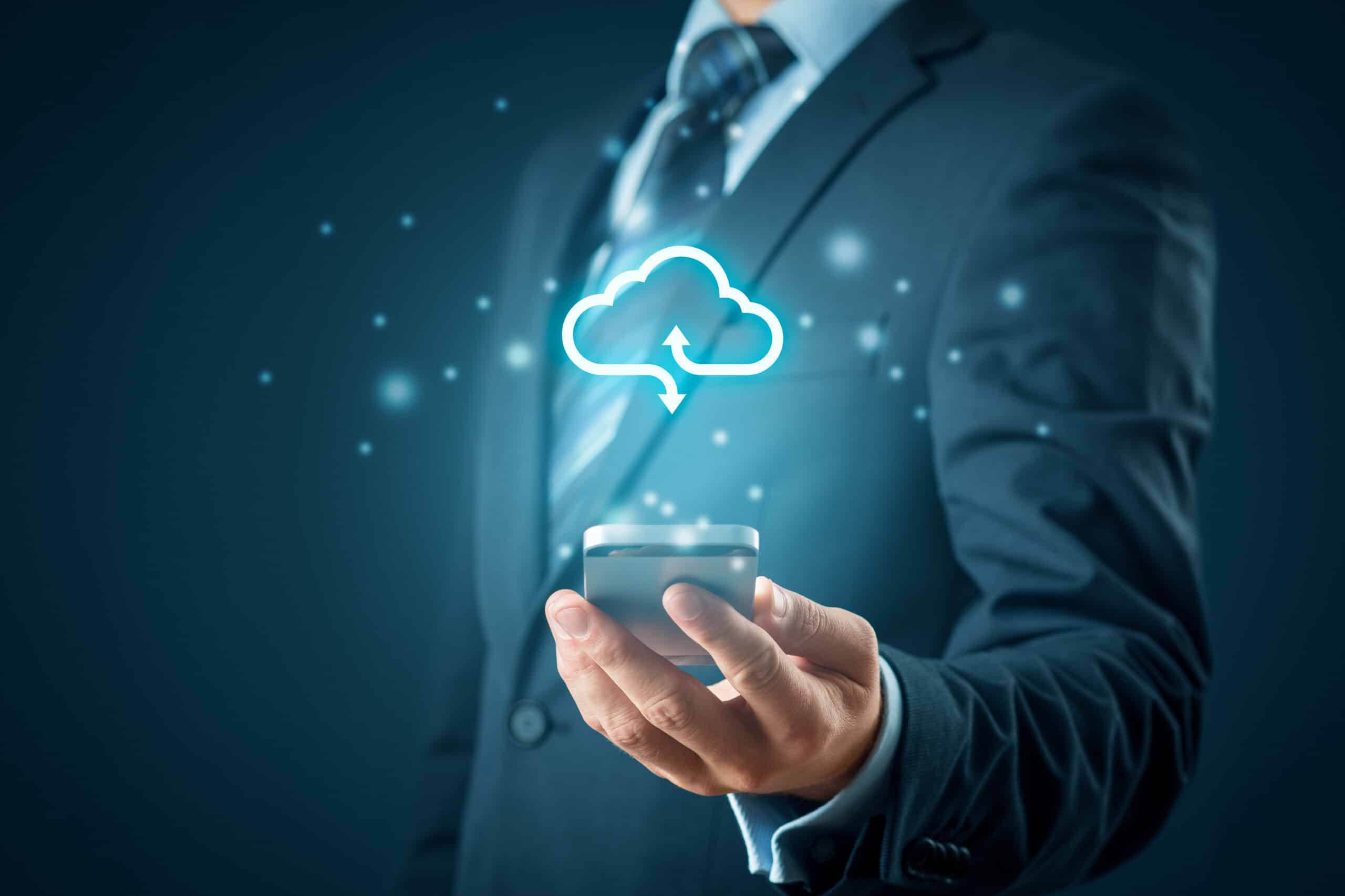 a man in a suit holding a cell phone with a cloud above it