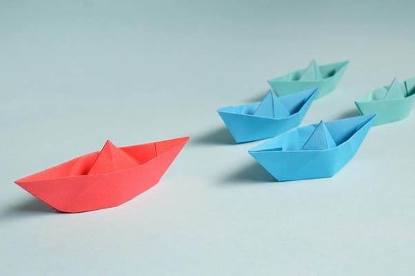 three paper boats sitting on top of each other