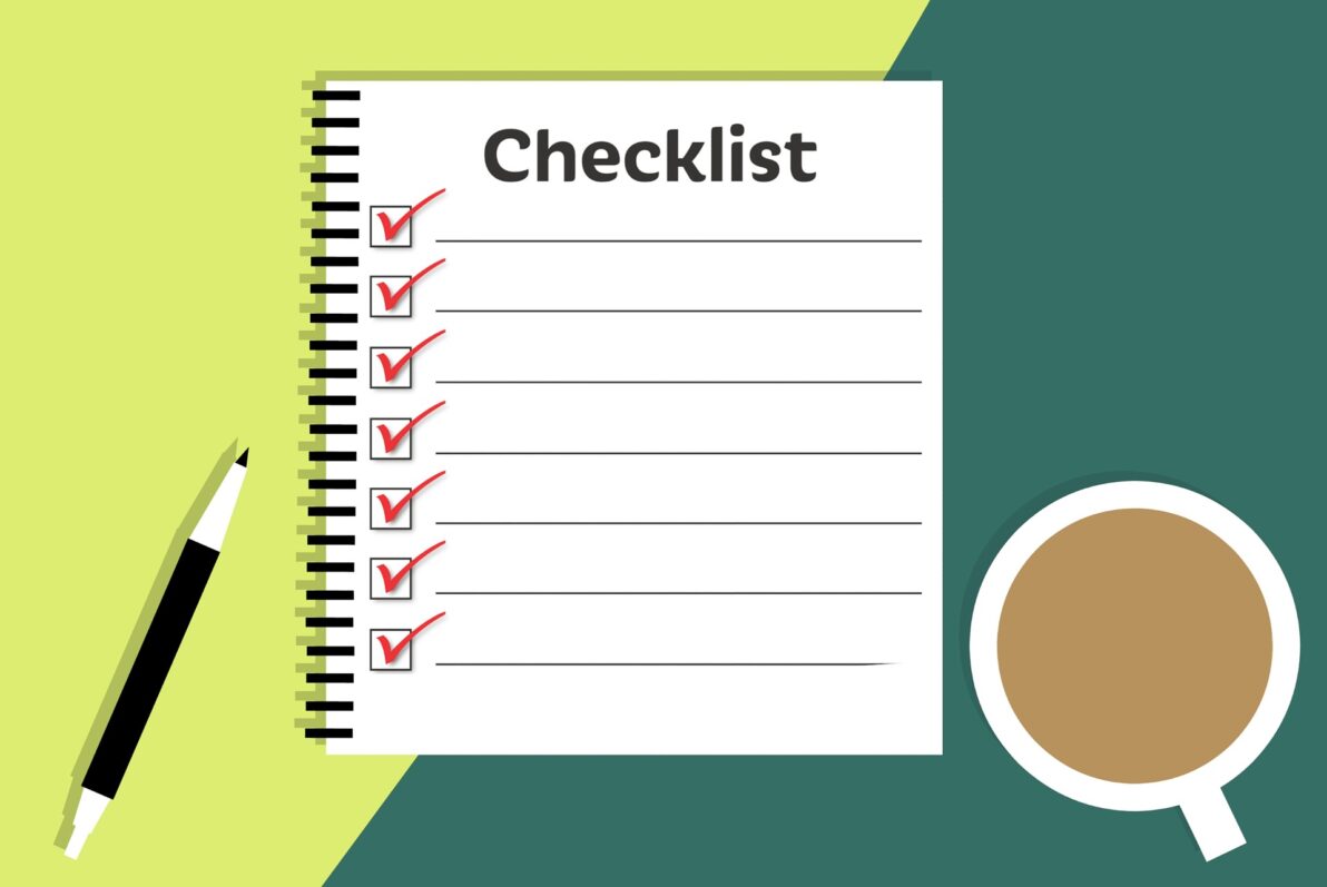 a checklist next to a cup of coffee