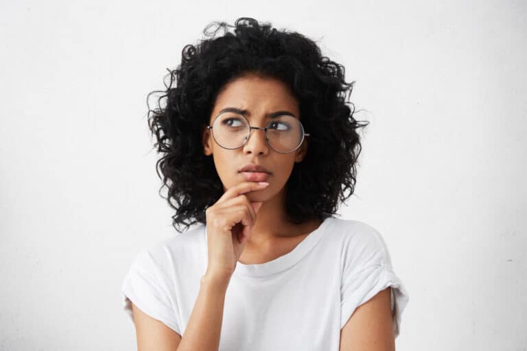 a woman with glasses is posing for the camera
